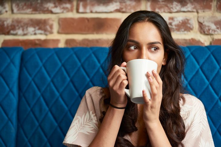 Young woman relaxing with a cup of coffee