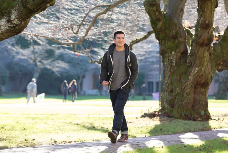 Mixed race student walking on campus