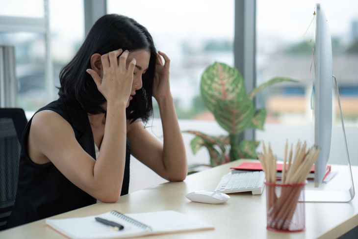 frustrated woman experiencing mental fatigue at work