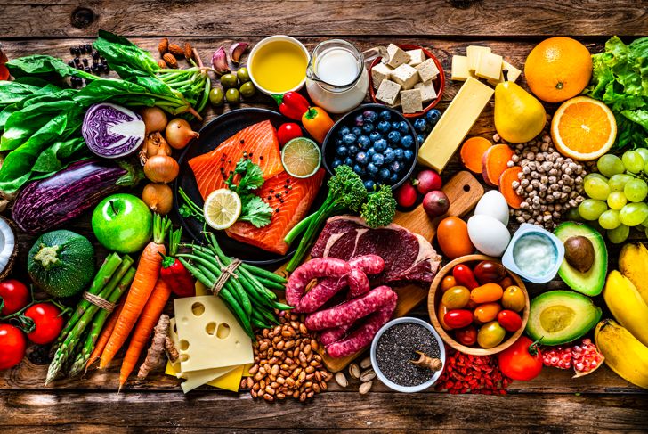 All kinds of food: carbohydrates, proteins and dietary fiber shot from above on wooden background.