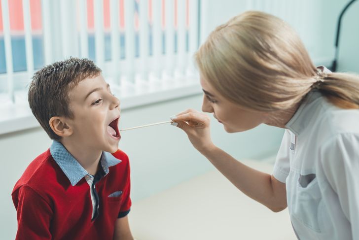 ENT doctor for children examines boy's throat
