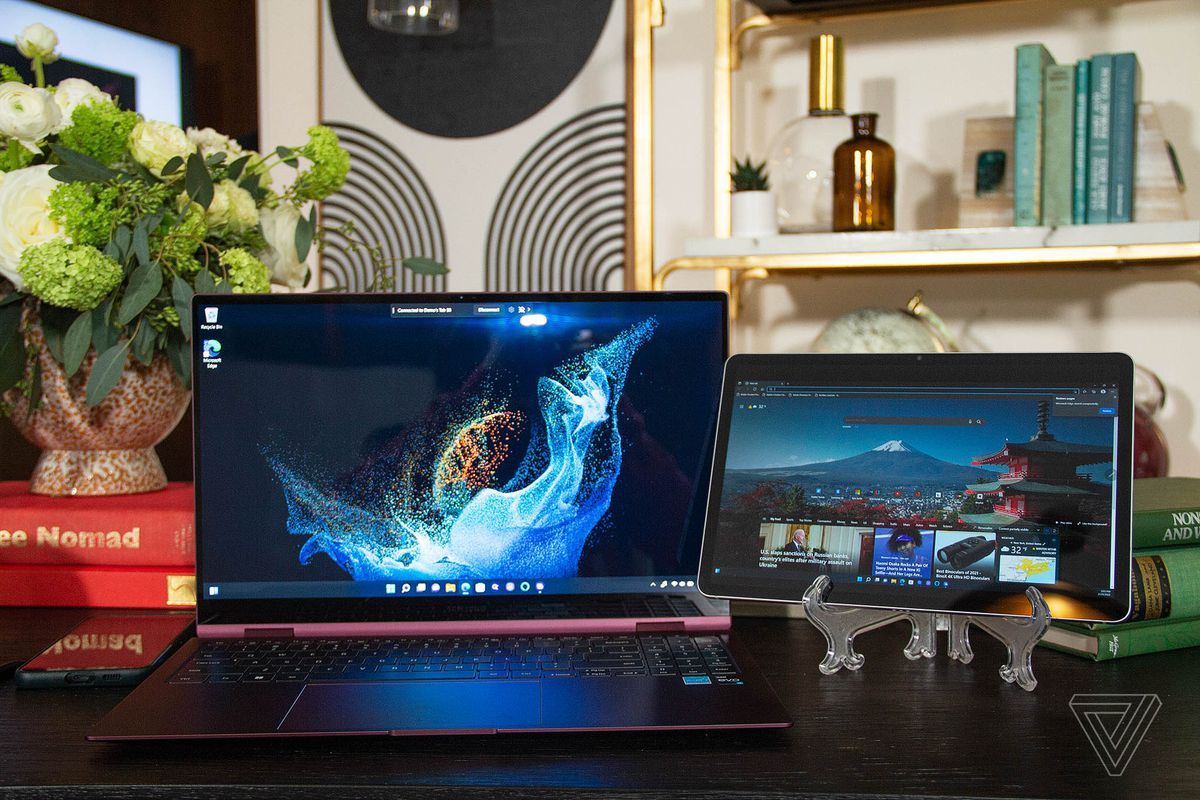The Samsung Galaxy Book 2 Pro 360 next to a Samsung Galaxy Tab S8.  The Galaxy Book shows a blue supernova on a black background.  The Tab S8 displays a Microsoft Edge home page.