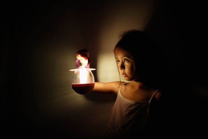 Girl holding electric battery lantern