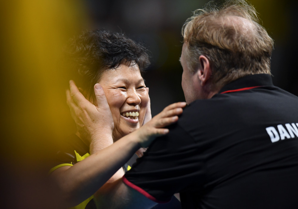 Ni Xialian celebrates with her coach and husband Tommy Danielsson after winning a women’s singles qualification round table tennis match during the Rio 2016 Olympic Games, Aug. 6, 2016. Jim Watson/AFP via VCG