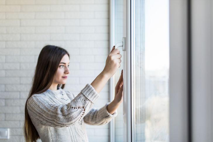 woman closes window
