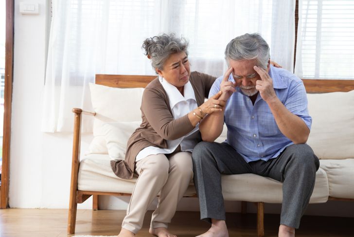 senior wife comforts senior husband who has Alzheimer's disease