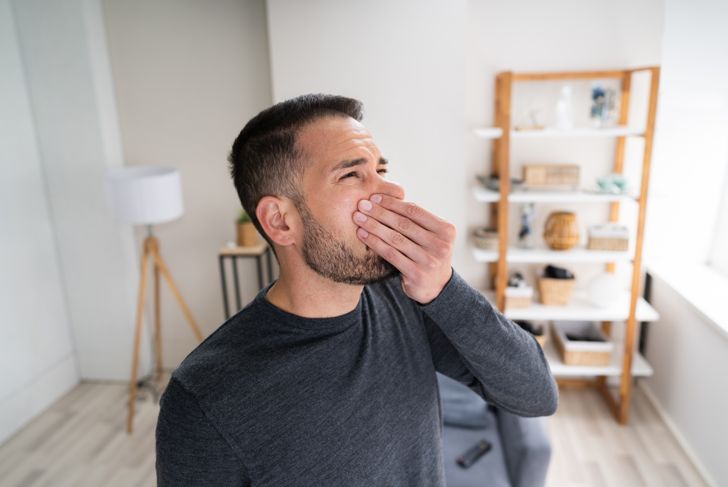 man covering his nose because of bad smell