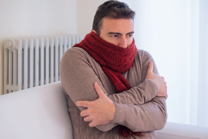 Man feels very cold at home with warm clothes