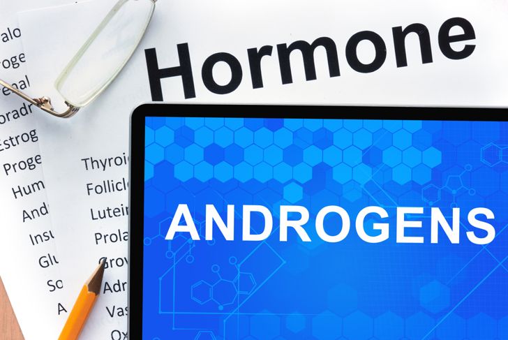 Papers with hormones list and tablet with words androgens.