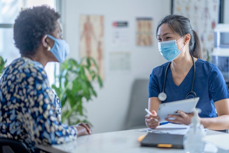 doctor and patient talking with masks
