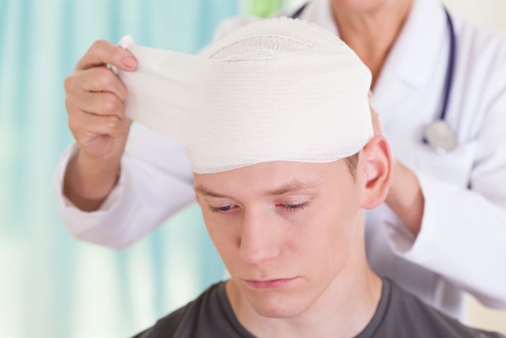 doctor putting bandage on a man's head