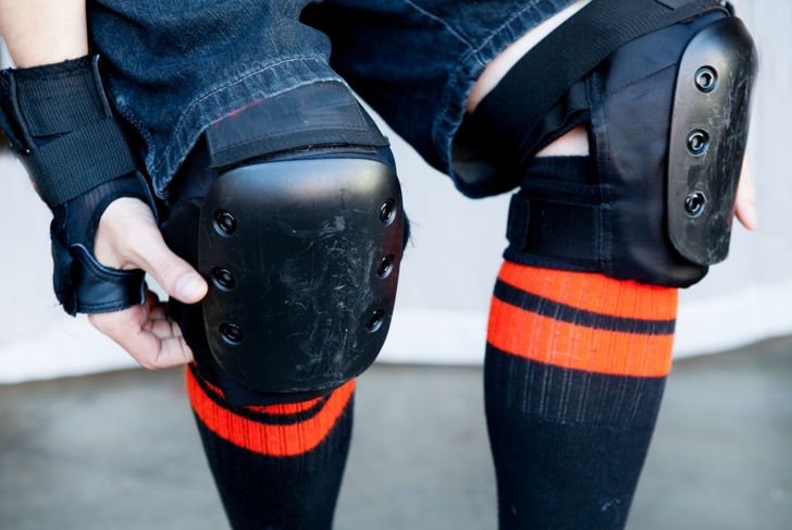 a man wears knee pads ready to skate