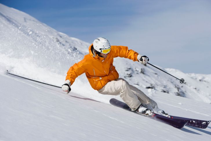 Skier cutting through powder snow
