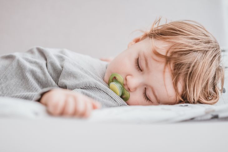 one year old boy sleeping with pacifier