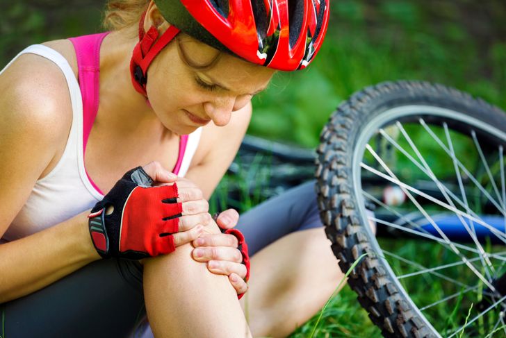 Young woman fell from mountain bike.