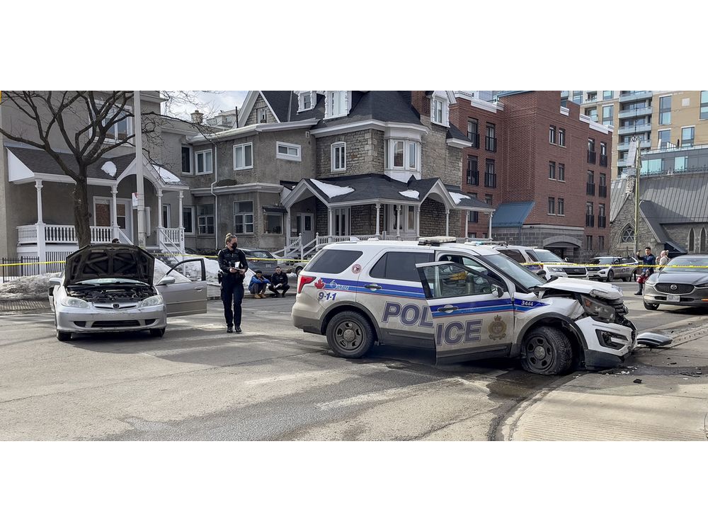 Ottawa police investigate a collision between one of their vehicles and a civilian vehicle at the intersection of King Edward Avenue and Stewart Street on Wednesday.