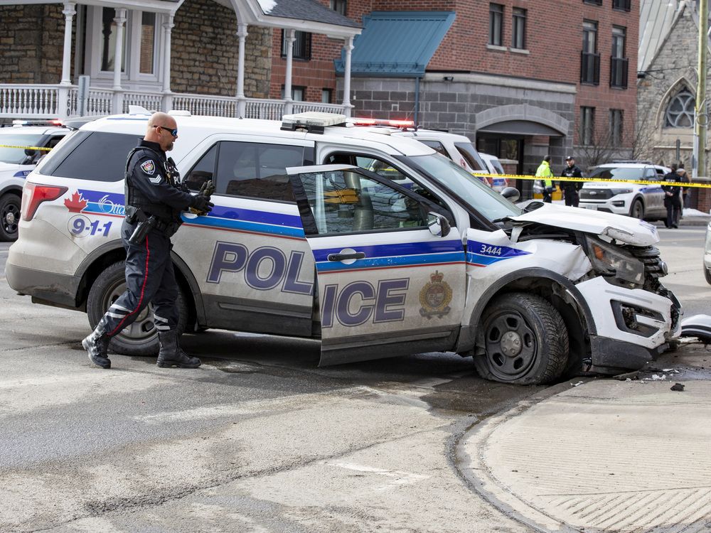 A damaged Ottawa Police Service cruiser sits at the intersection following a collision of King Edward Avenue and Stewart Street in Sandy Hill after a collision with a civilian vehicle on Wednesday afternoon.
